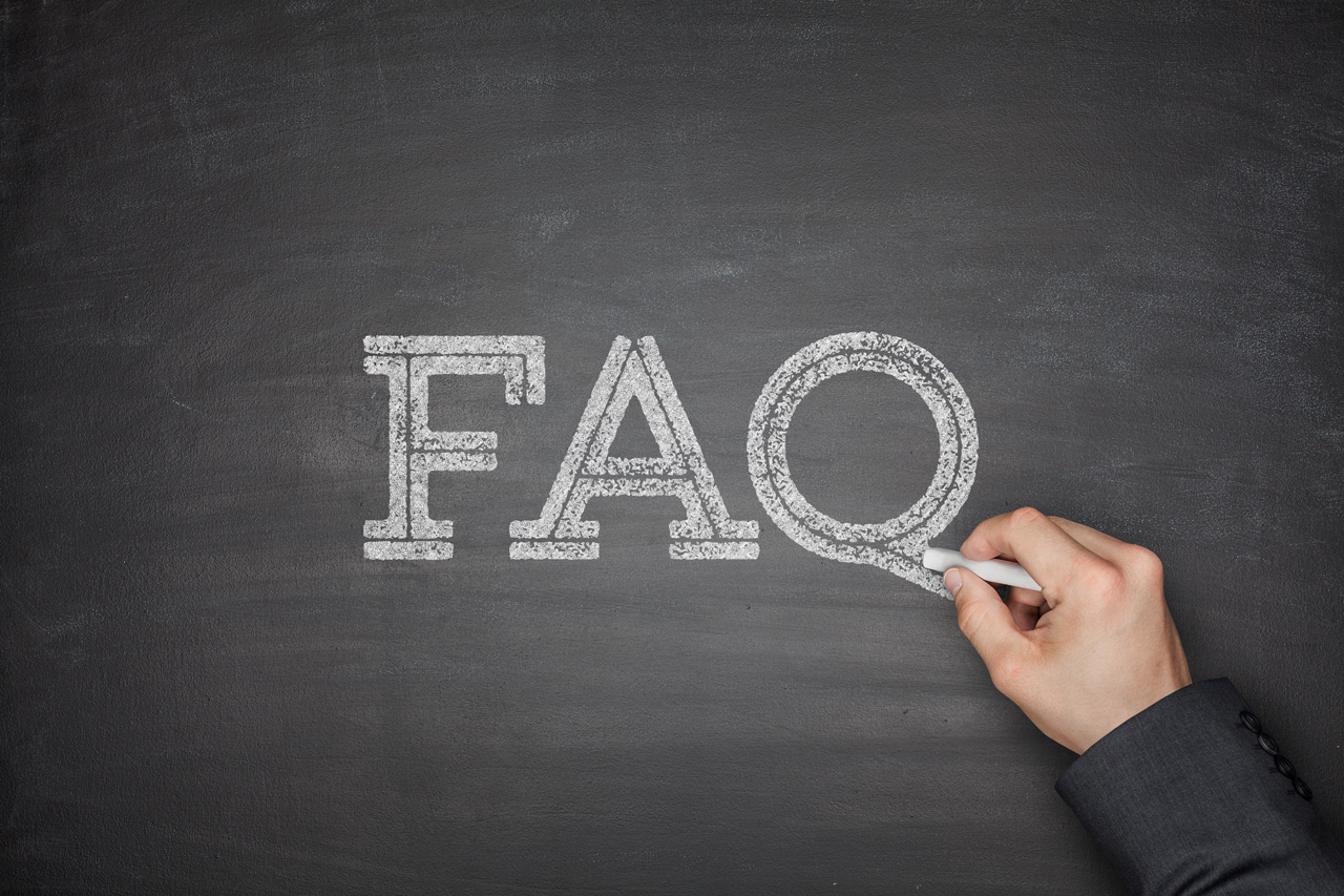 The abreviation FAQ written on a chalkboard